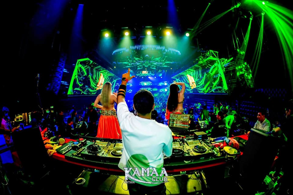 DJ booth glowing under green lasers at Kamaa Club Pattaya