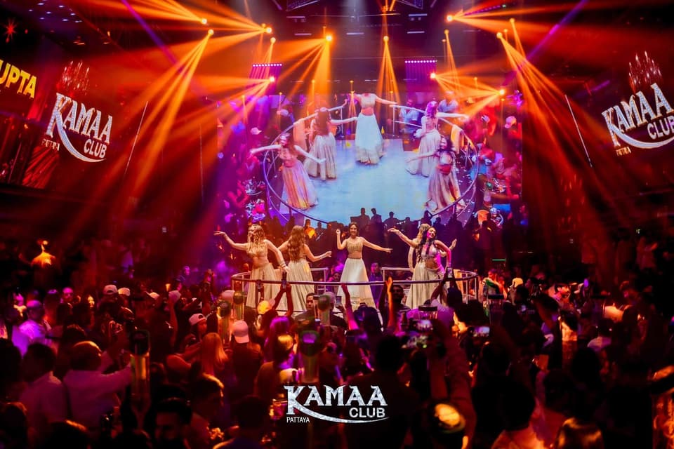 Dancers performing on the main stage under purple and orange lights at Kamaa Club Pattaya