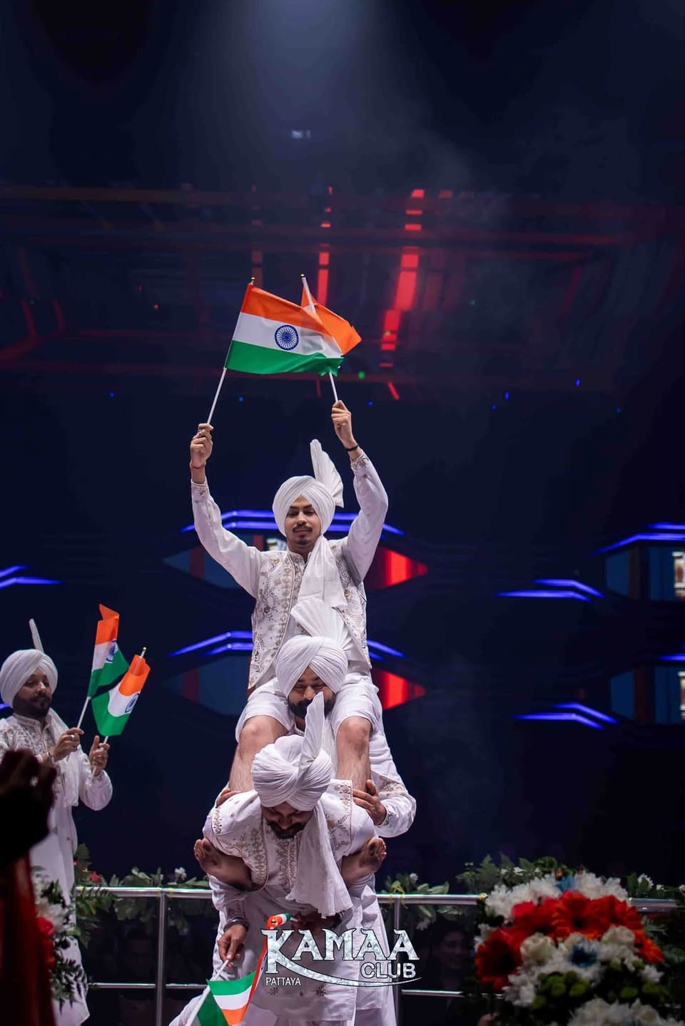 Performers in white forming a human tower with Indian flags at Kamaa Club Pattaya