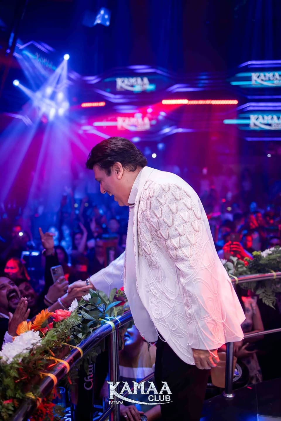 Guest performer in a white jacket greeting the crowd at Kamaa Club Pattaya