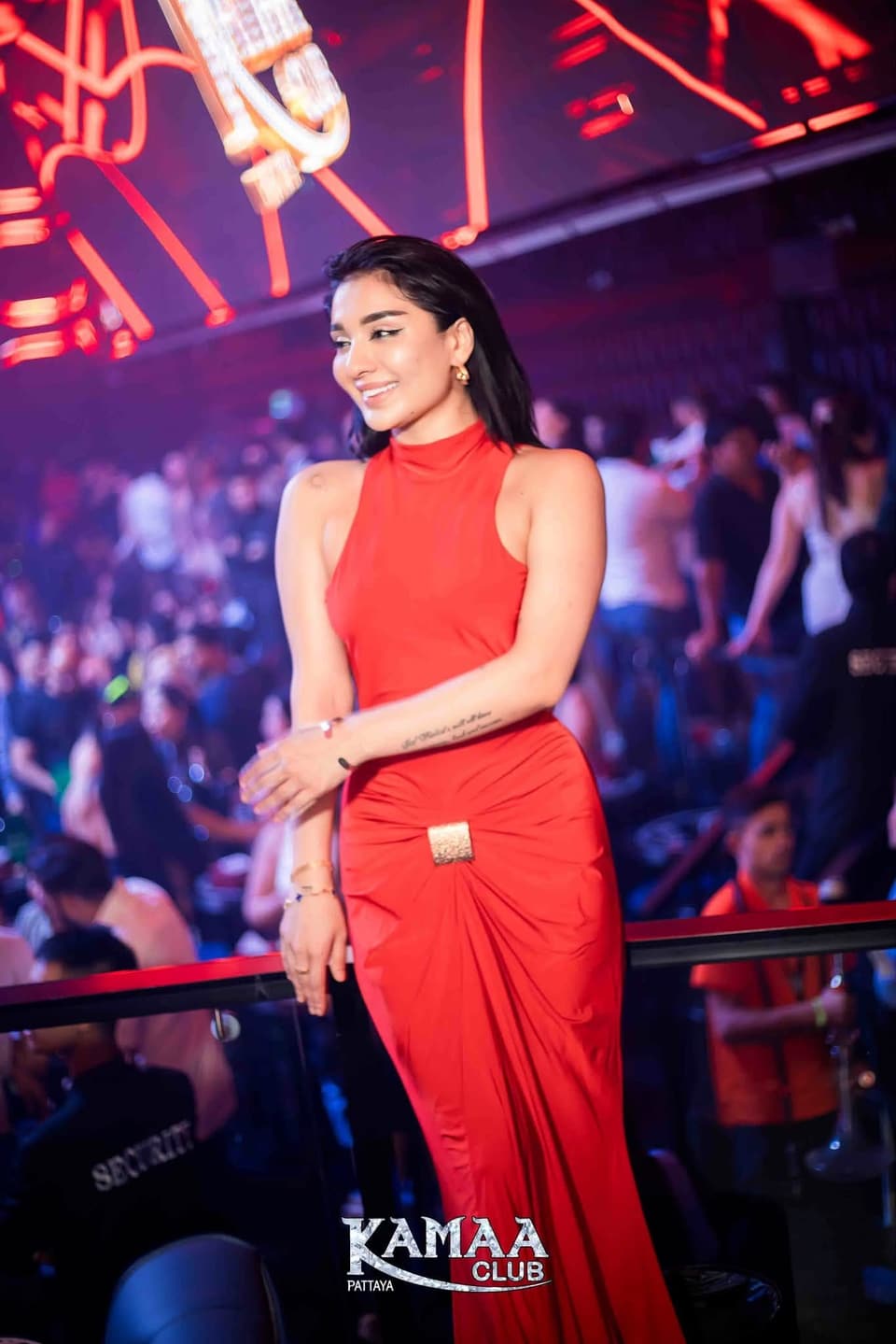 Guest in a red halter dress under purple club lights at Kamaa Club Pattaya