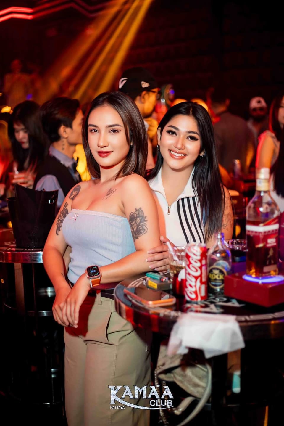 Two friends celebrating at a VIP table at Kamaa Club Pattaya