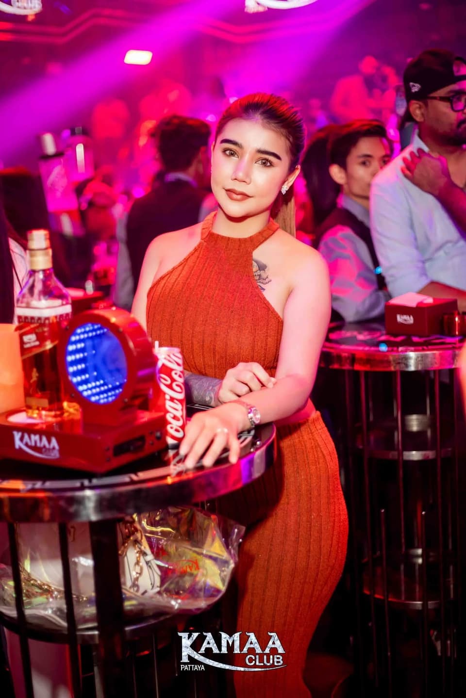 Guest in an orange dress beside a bottle-service table at Kamaa Club Pattaya