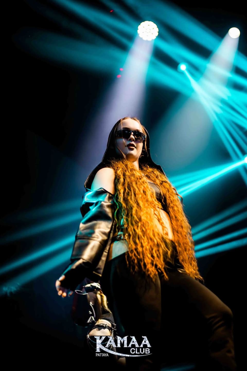 Performer in a long fringed costume under cyan beams at Kamaa Club Pattaya