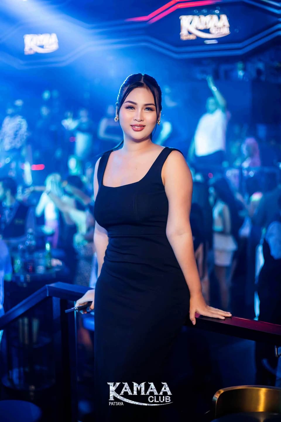 Guest in a black dress under blue lights at Kamaa Club Pattaya
