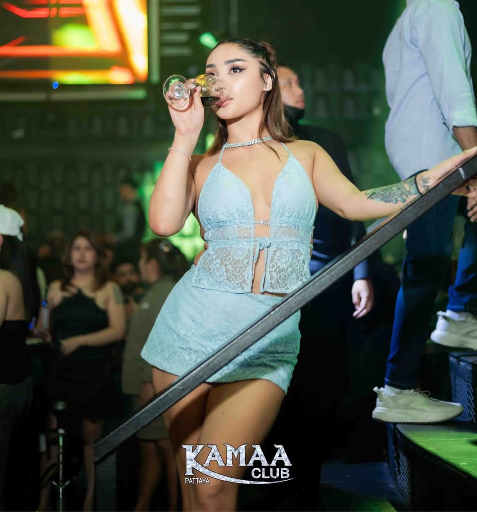 Guest in a pale blue outfit leaning on the rail at Kamaa Club Pattaya