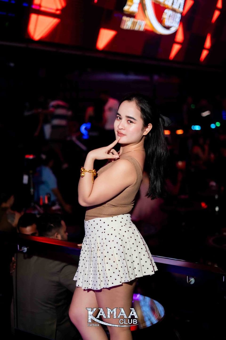Guest in a white skirt posing on the upper level at Kamaa Club Pattaya